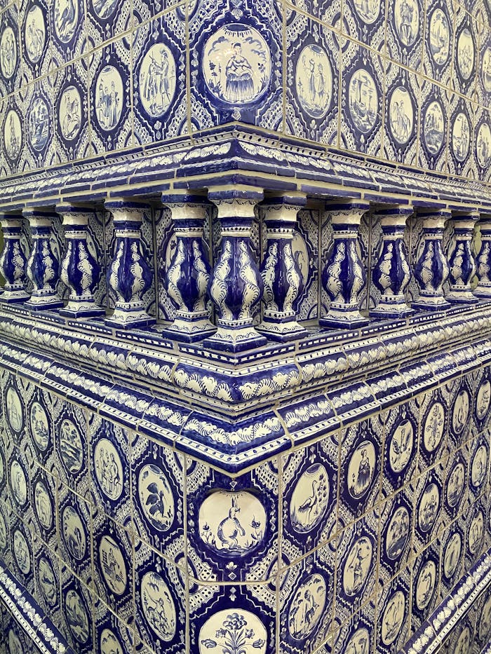 Detailed view of a blue and white ceramic tile wall with intricate, traditional patterns.