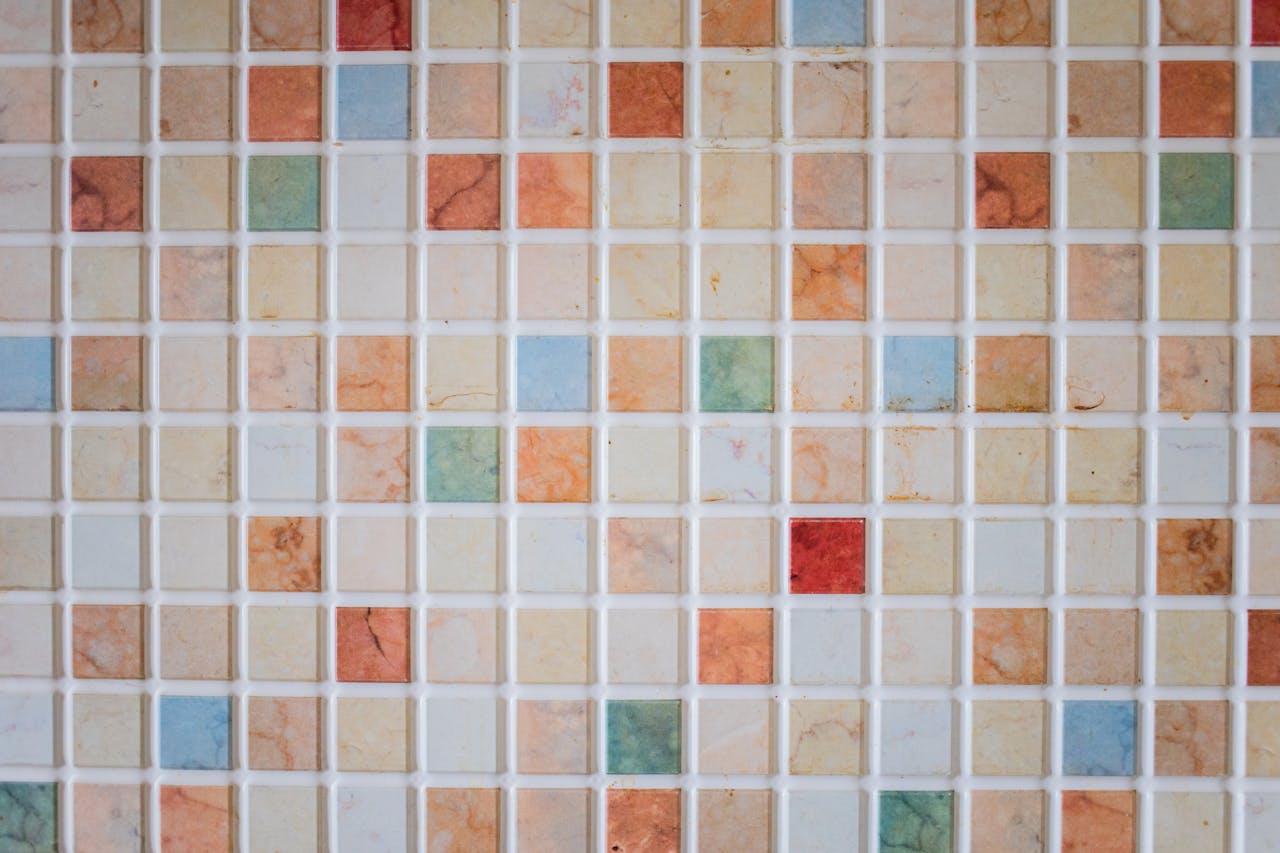 Bright and colorful mosaic tiles arranged in a square pattern creating a vibrant backdrop.